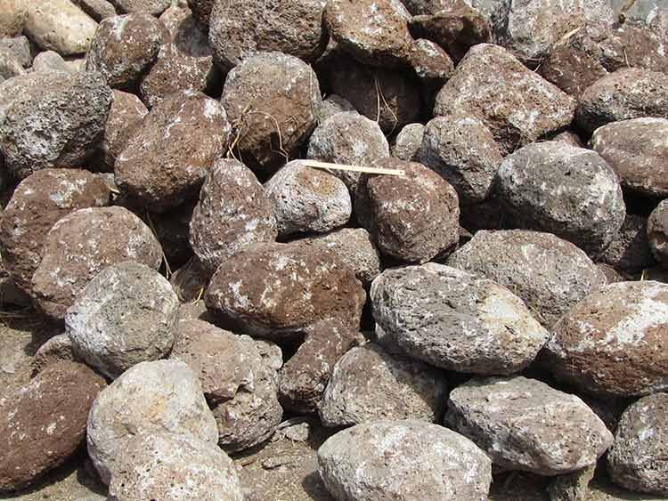 Pile of Porous, Irregularly Shaped Brown and Gray Rocks on the Ground — Kuranda Landscape Supplies in Kuranda, QLD