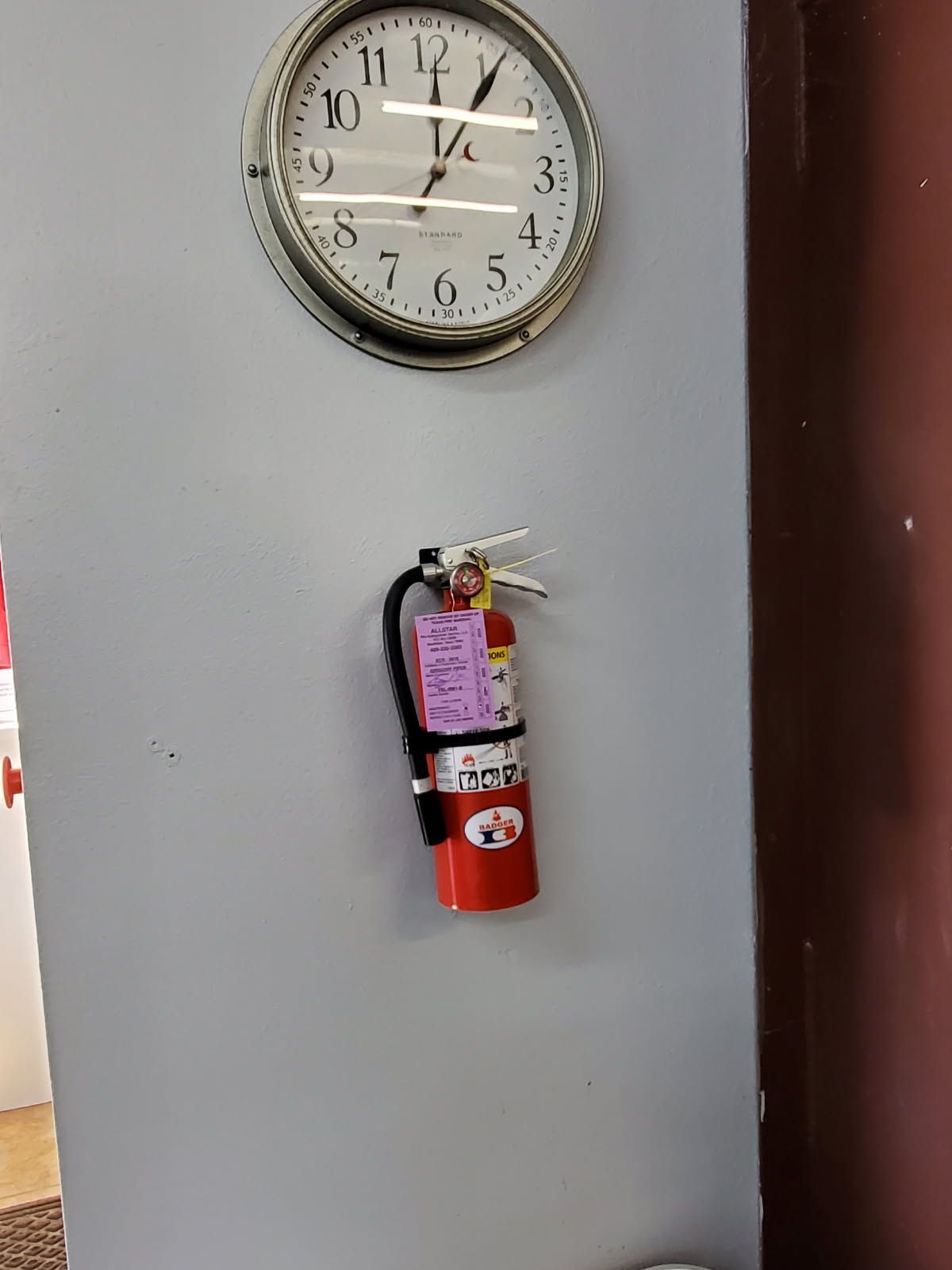 Four red fire extinguishers, labeled