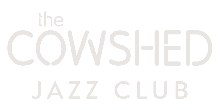 A white logo for the cowshed jazz club on a white background.