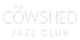 A white logo for the cowshed jazz club on a white background.