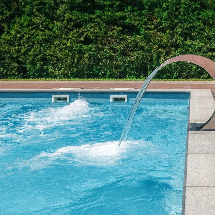 A swimming pool with a waterfall coming out of it