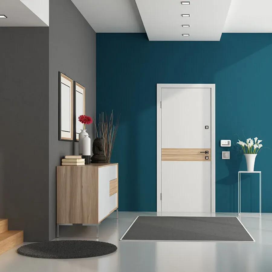 A hallway with blue walls and a white door