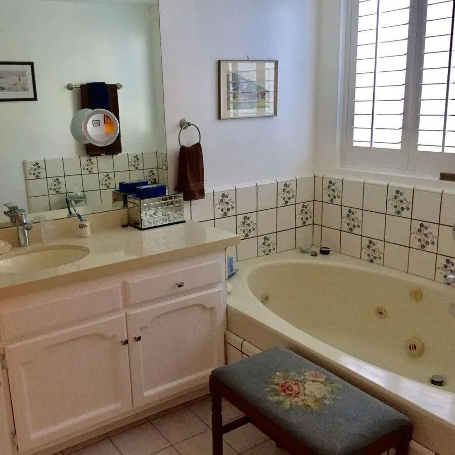 A bathroom with a jacuzzi tub and a sink