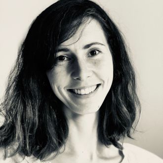 Black and white photo of Mel Cross, smiling and looking at the camera.