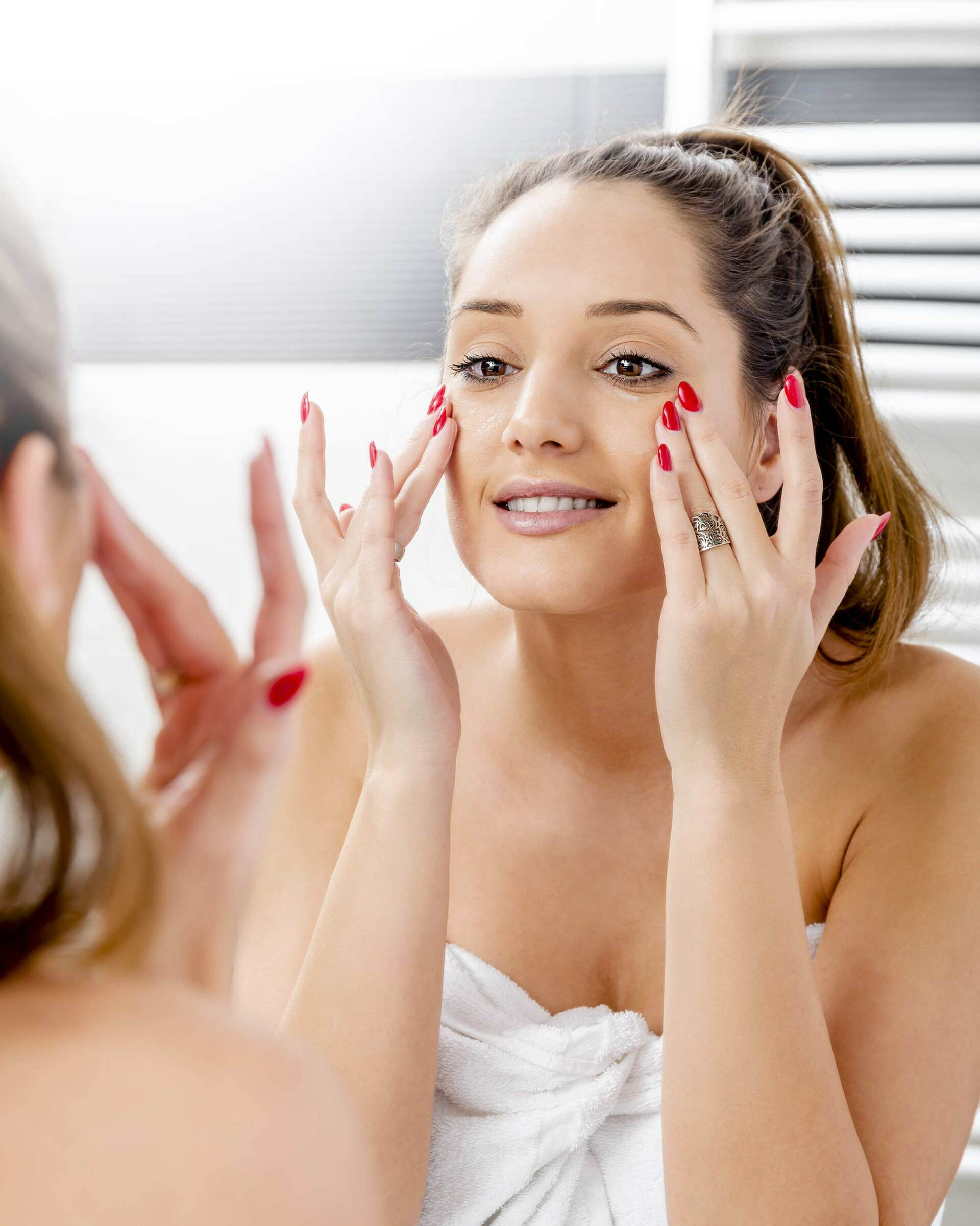 woman looking at self in mirror