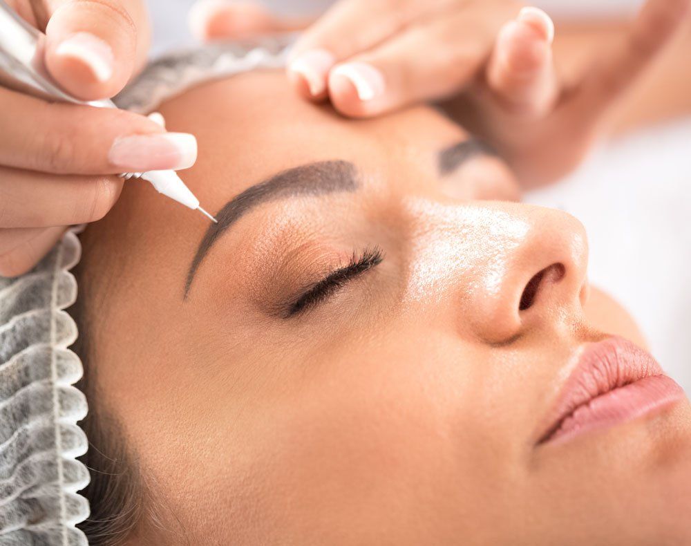 woman with eyebrow microblading