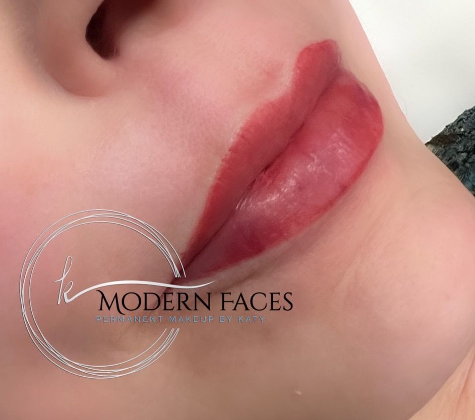 Close-up of lips with glossy red cosmetic treatment and a Modern Faces watermark