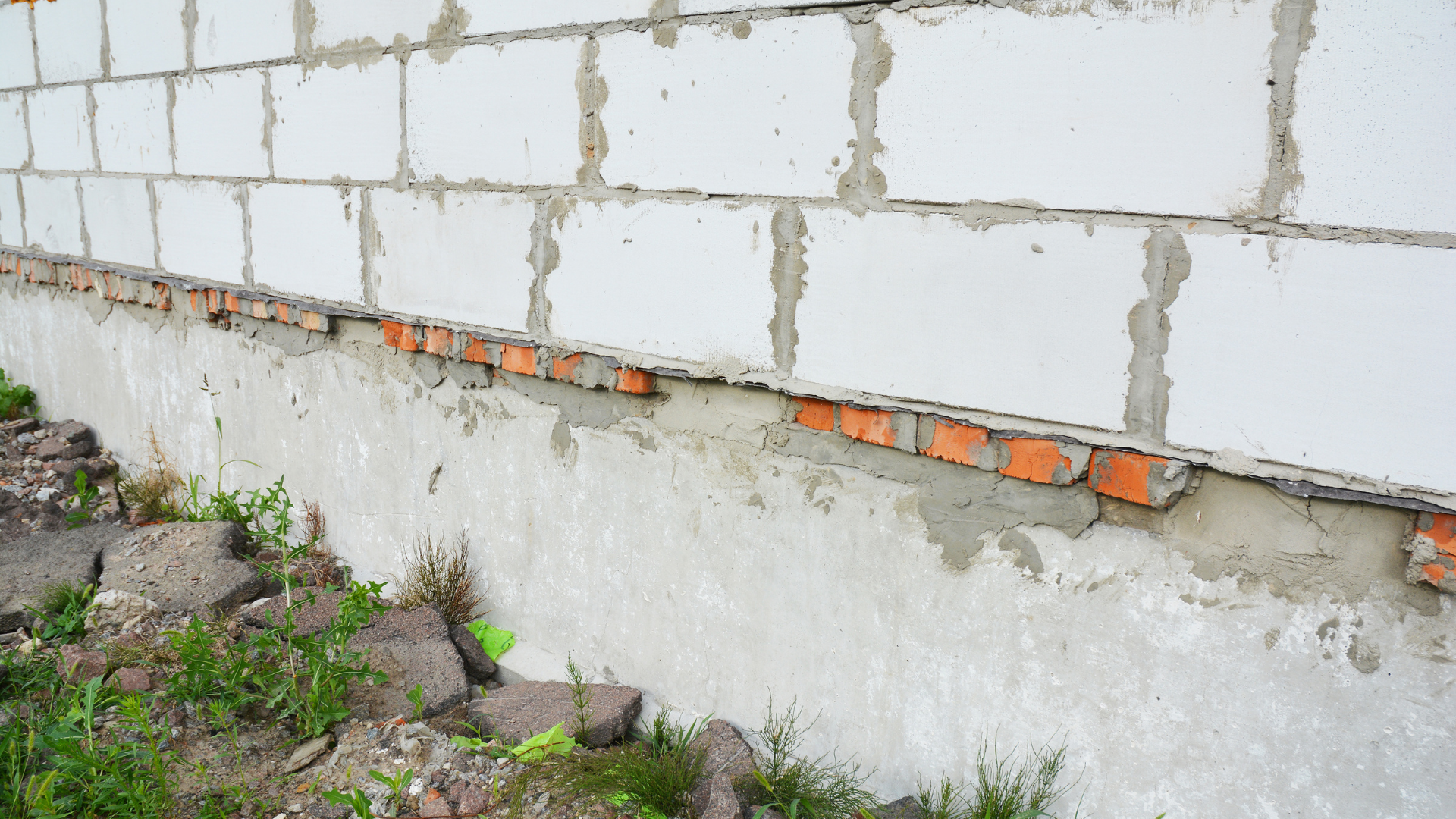 Waterproofing specialists installing basement leak repair system