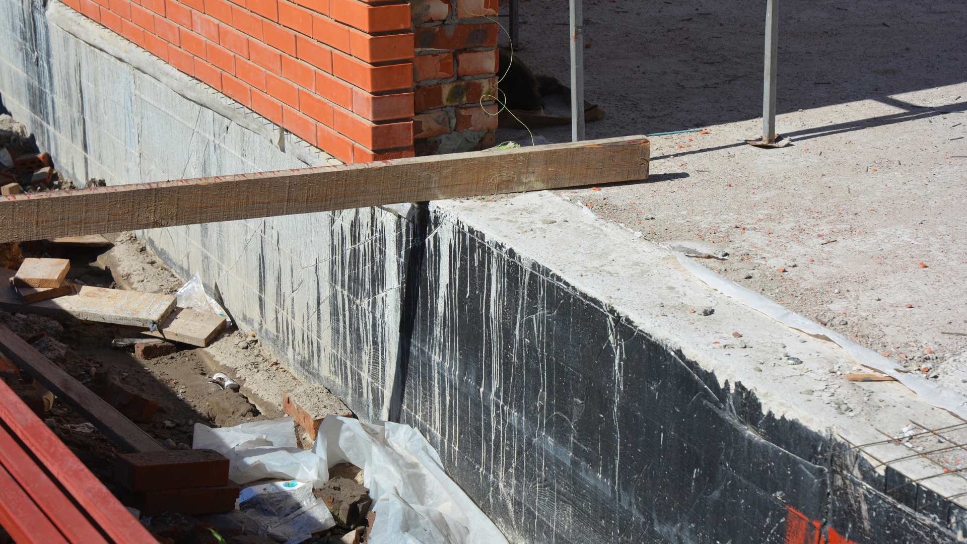 Concrete contractors using plate compactor for soil compaction work
