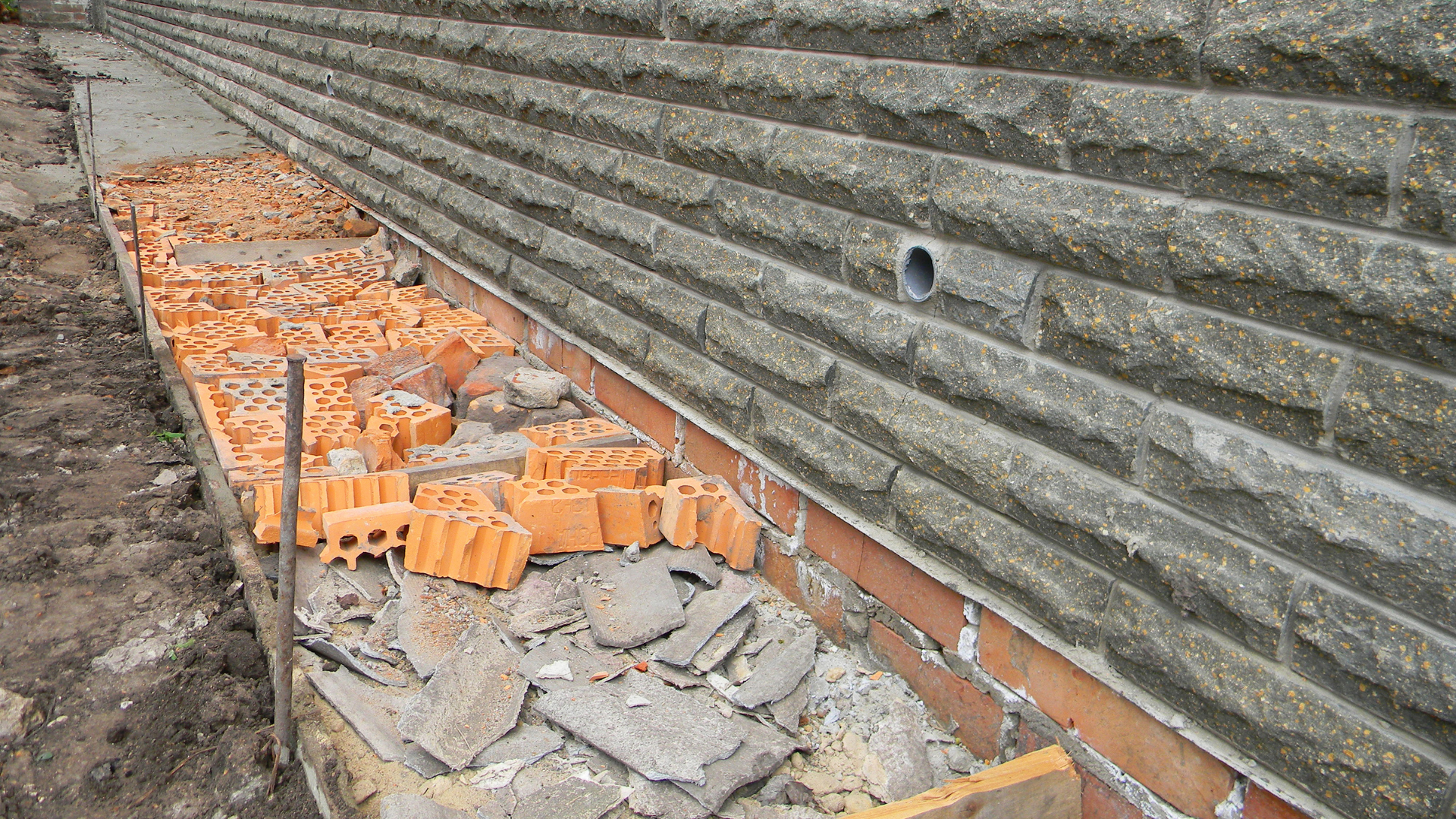 Wet basement repair work with sump pump installation system
