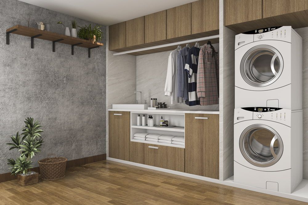 Laundry Room With a Washer and Dryer Stacked on Top of Each Other — Ken Willis Joinery Pty Ltd In South Grafton, NSW