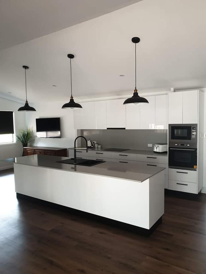 A White kitchen space with black fittings and lights — Ken Willis Joinery Pty Ltd In South Grafton, NSW