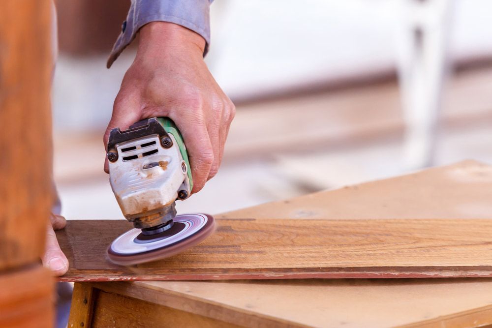 Person is Sanding a Piece of Wood With a Sander — Ken Willis Joinery Pty Ltd In South Grafton, NSW