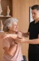 Physical therapist guiding a client through an arm stretch in a bright clinic room
