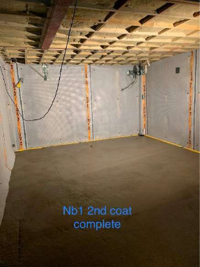 A room with a wooden ceiling and a concrete floor.