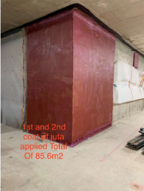 A red wall with the words 1st and 2nd coat of juta applied total of 85.6m2 on it