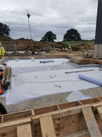 A group of construction workers are working on a construction site.