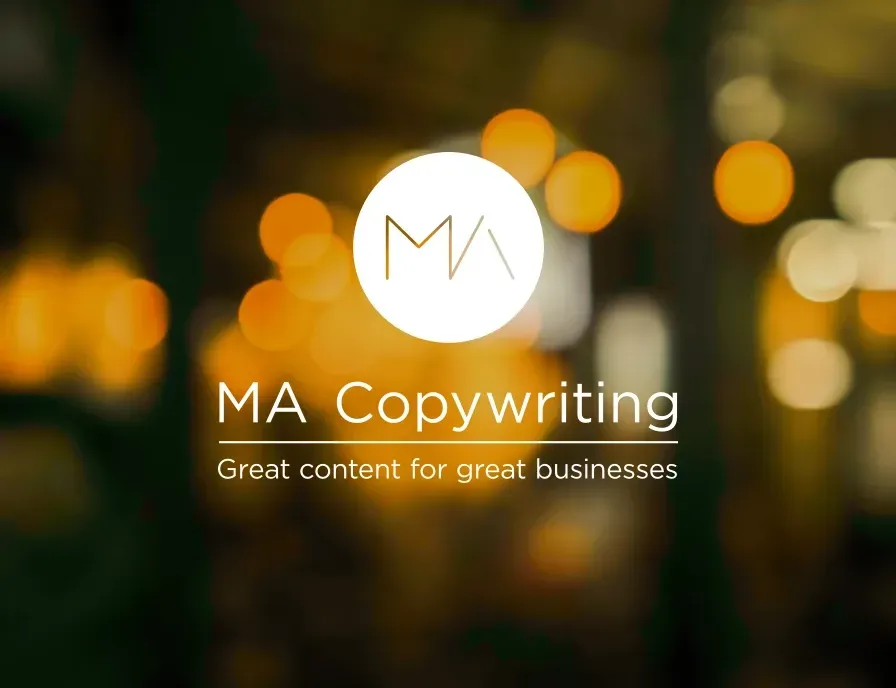 A ma copywriting logo with a blurry background