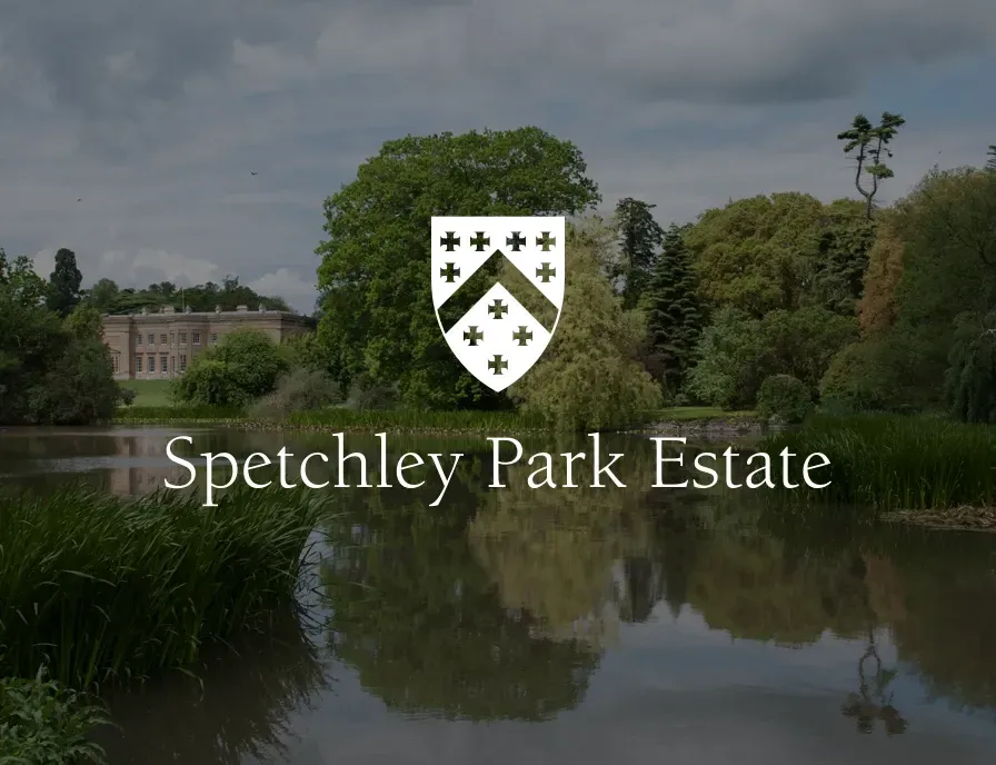 A logo for spetchley park estate with a lake in the background