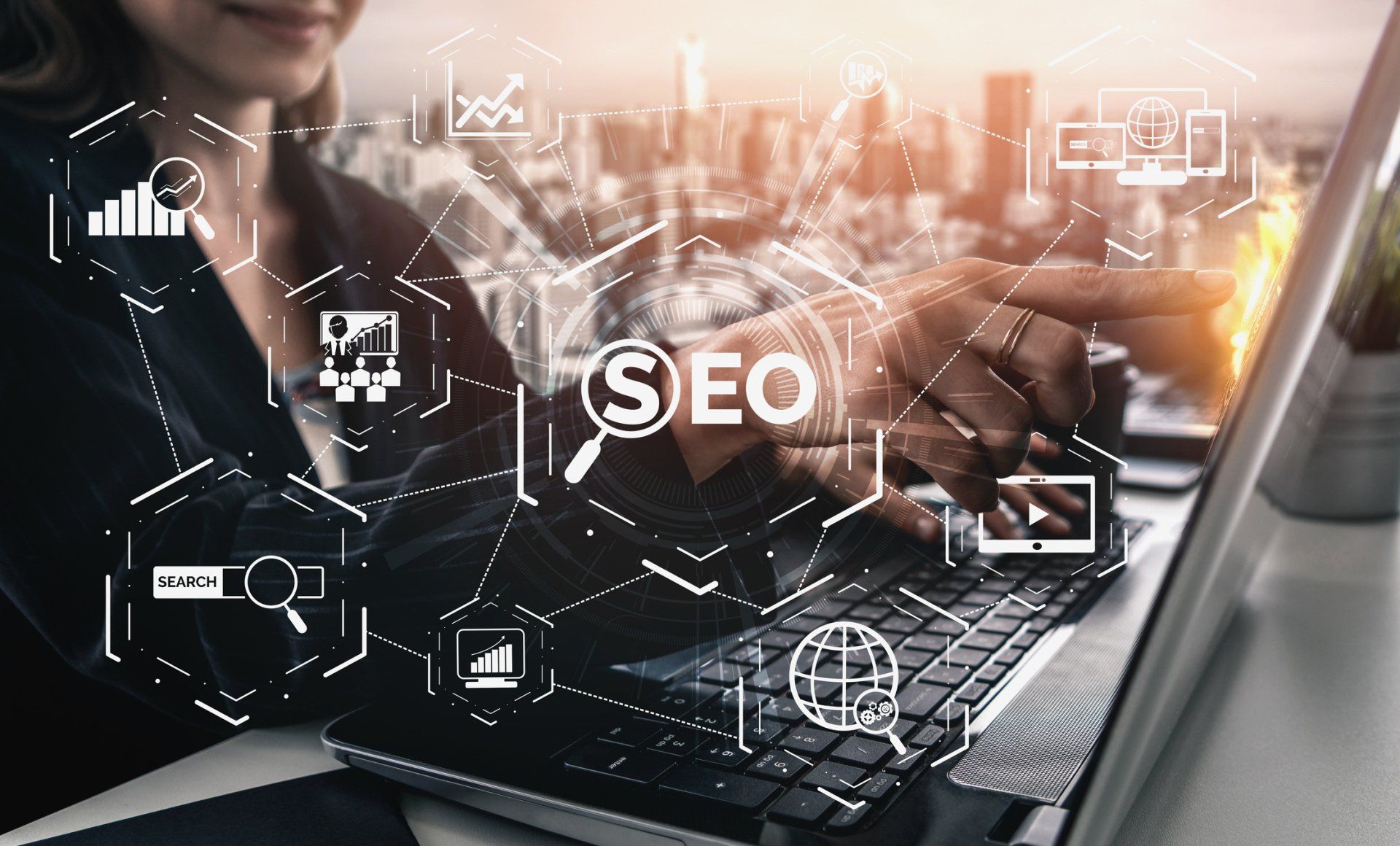 A woman is typing on a laptop with the word seo on the screen
