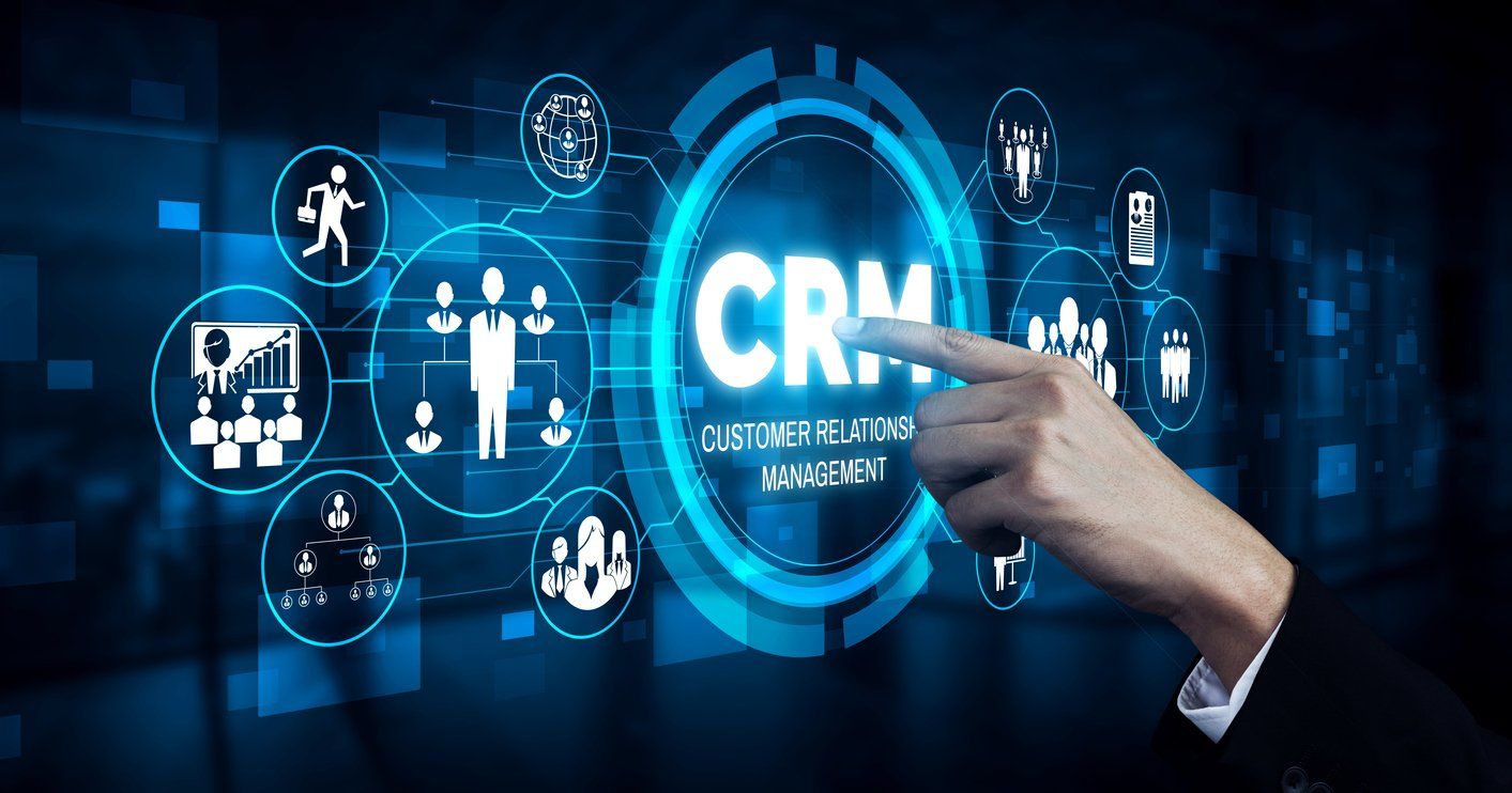 A hand is pointing at a screen that says crm