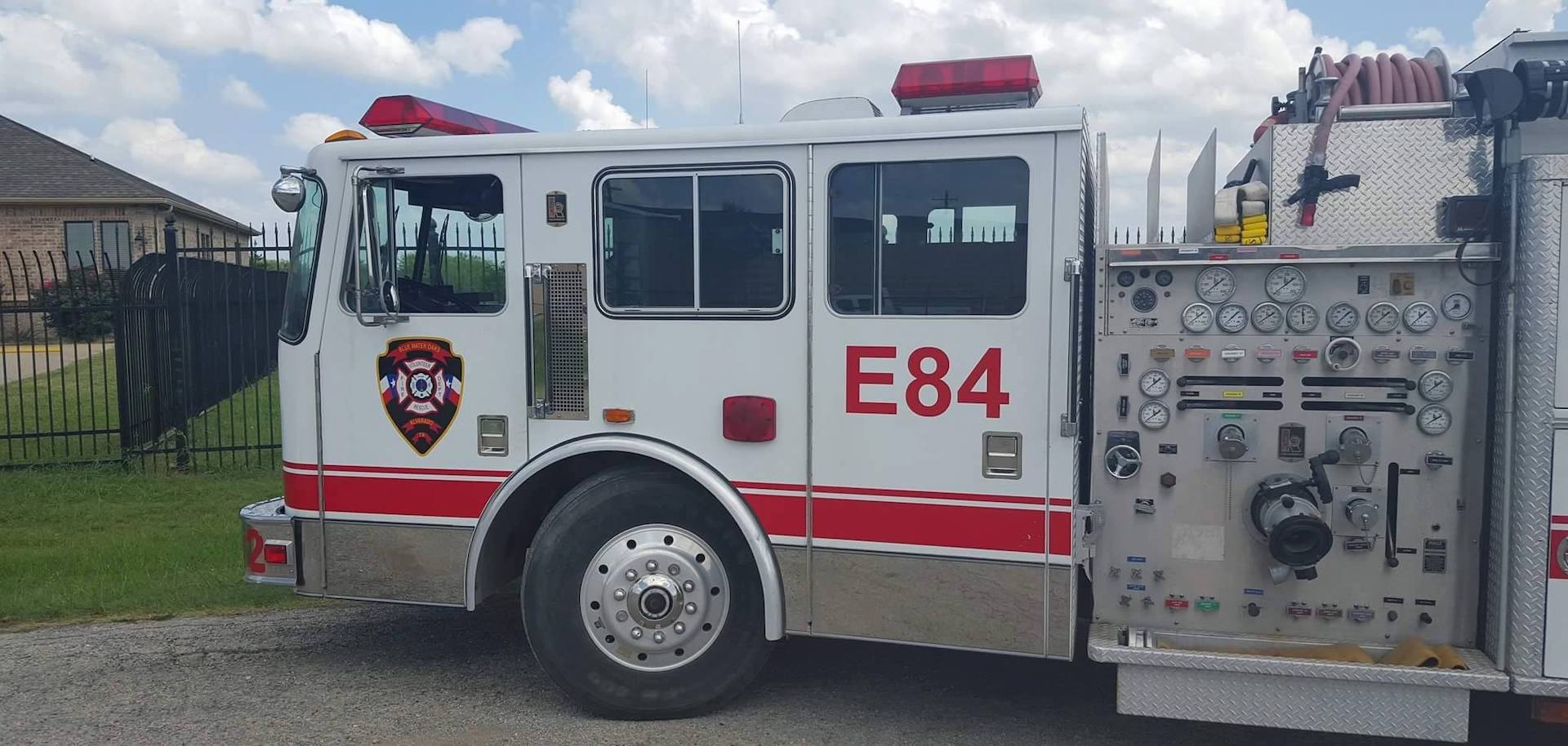 A Blue Water Oaks fire truck with the number 84 on the side is parked on the side of the road.