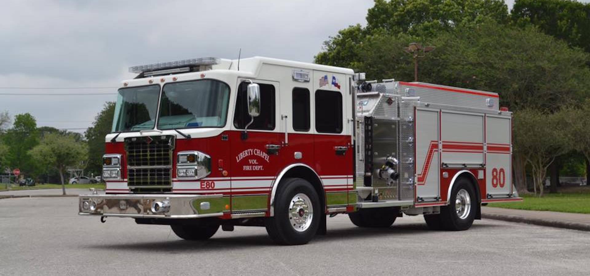 A red and white fire truck with the number 80 on the side