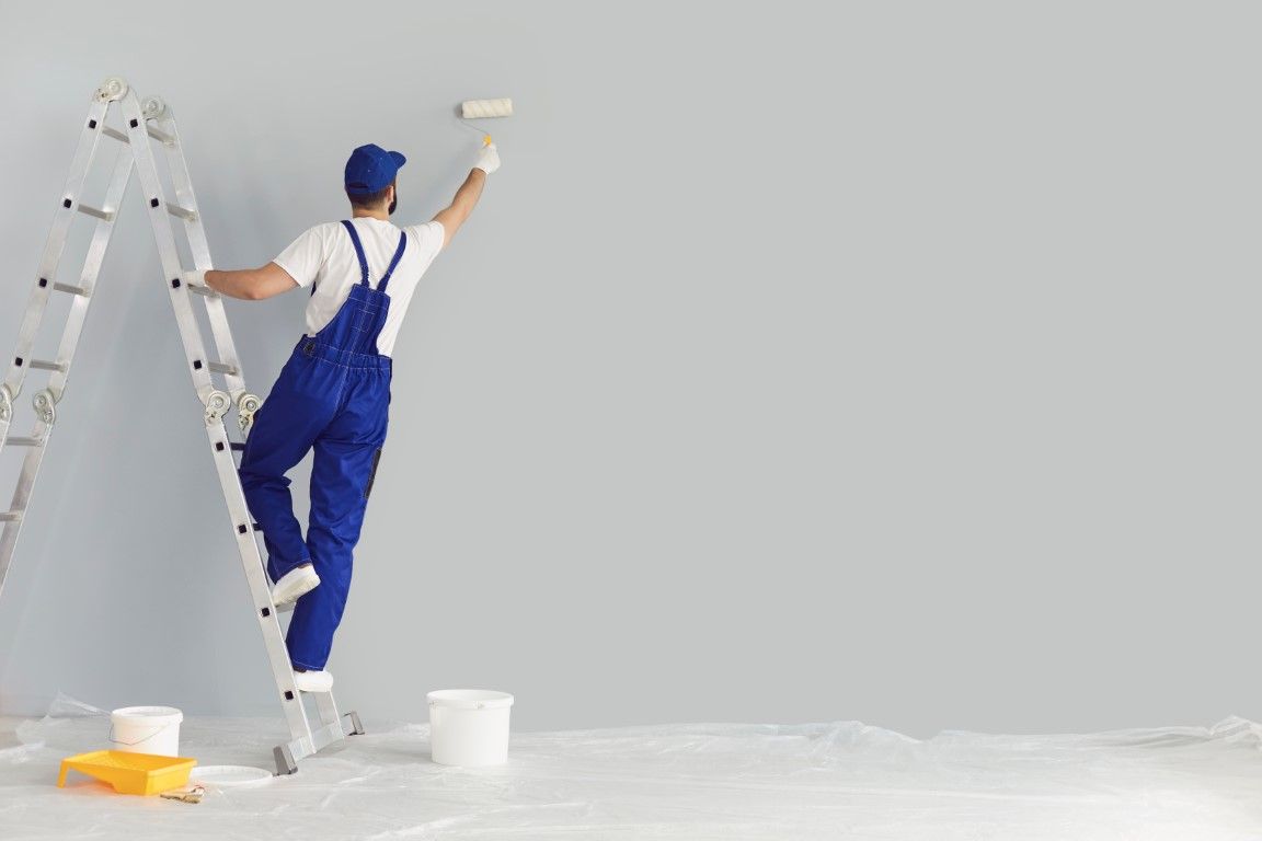 a painter painting a building