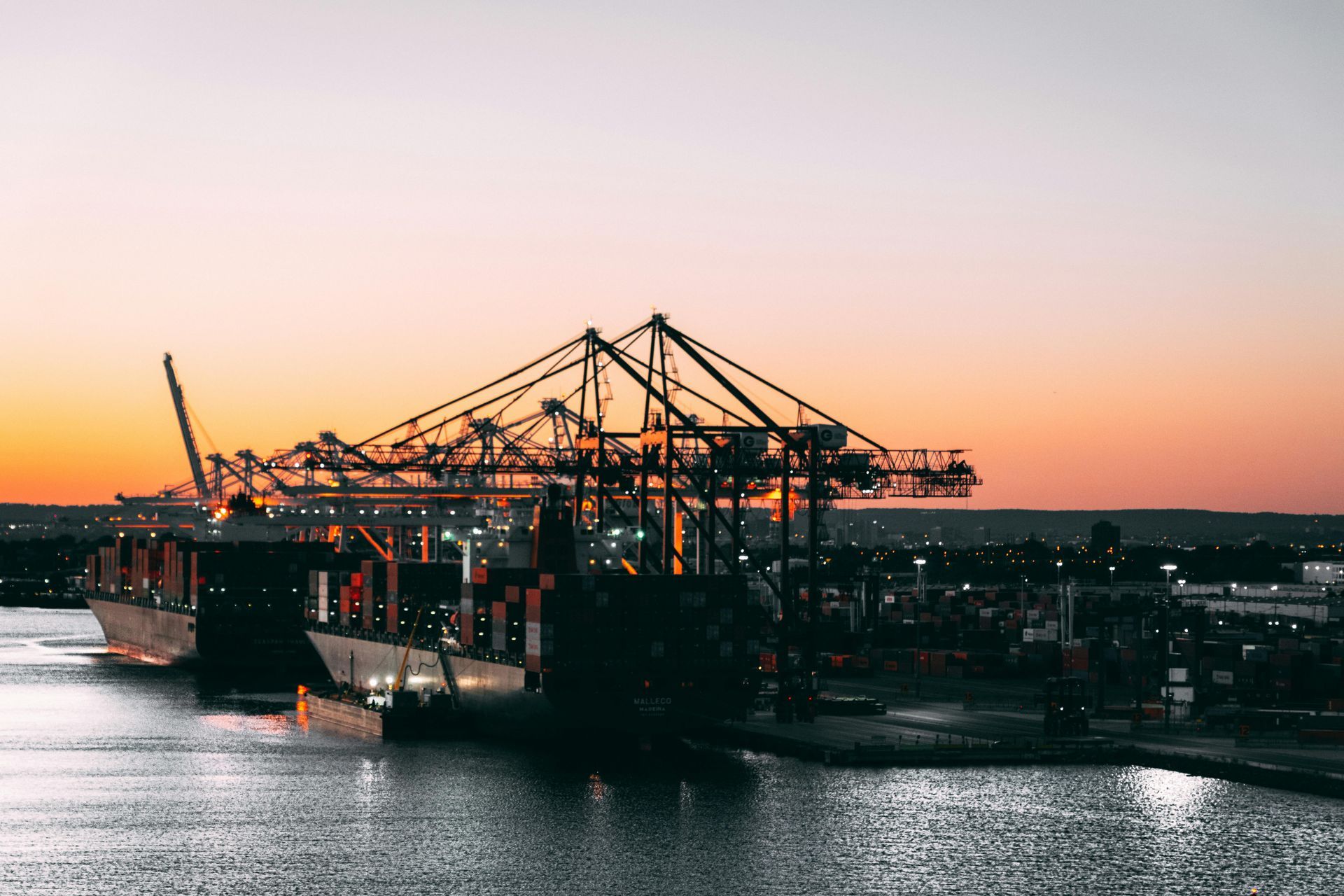 A large container ship is docked at a port
