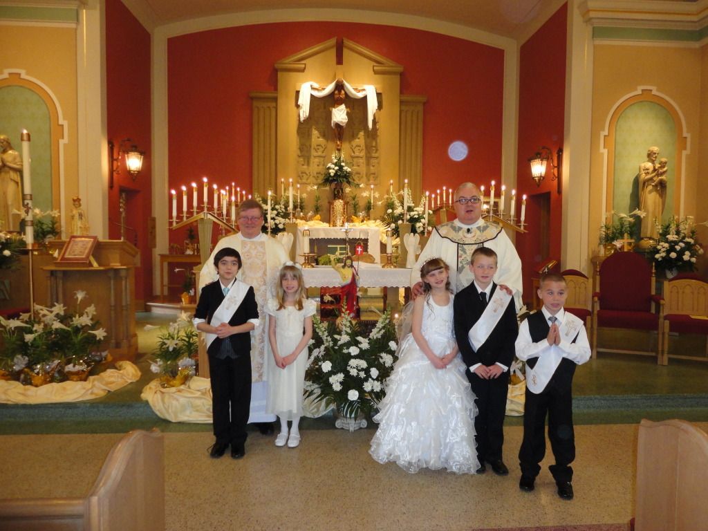 Wedding party posing in front of a decorated altar inside a church