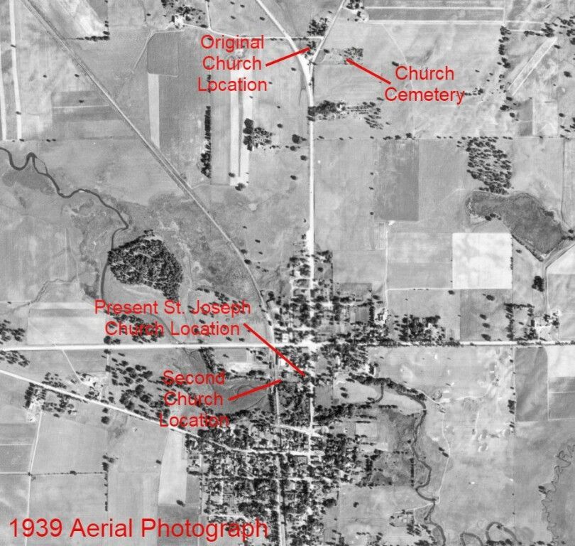 1939 aerial photo with red labels marking church, cemetery, and school locations in a rural town