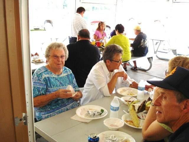 People eating at tables in a bright cafeteria or dining hall