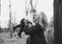 A woman is holding a baby in her arms and kissing it on the cheek.