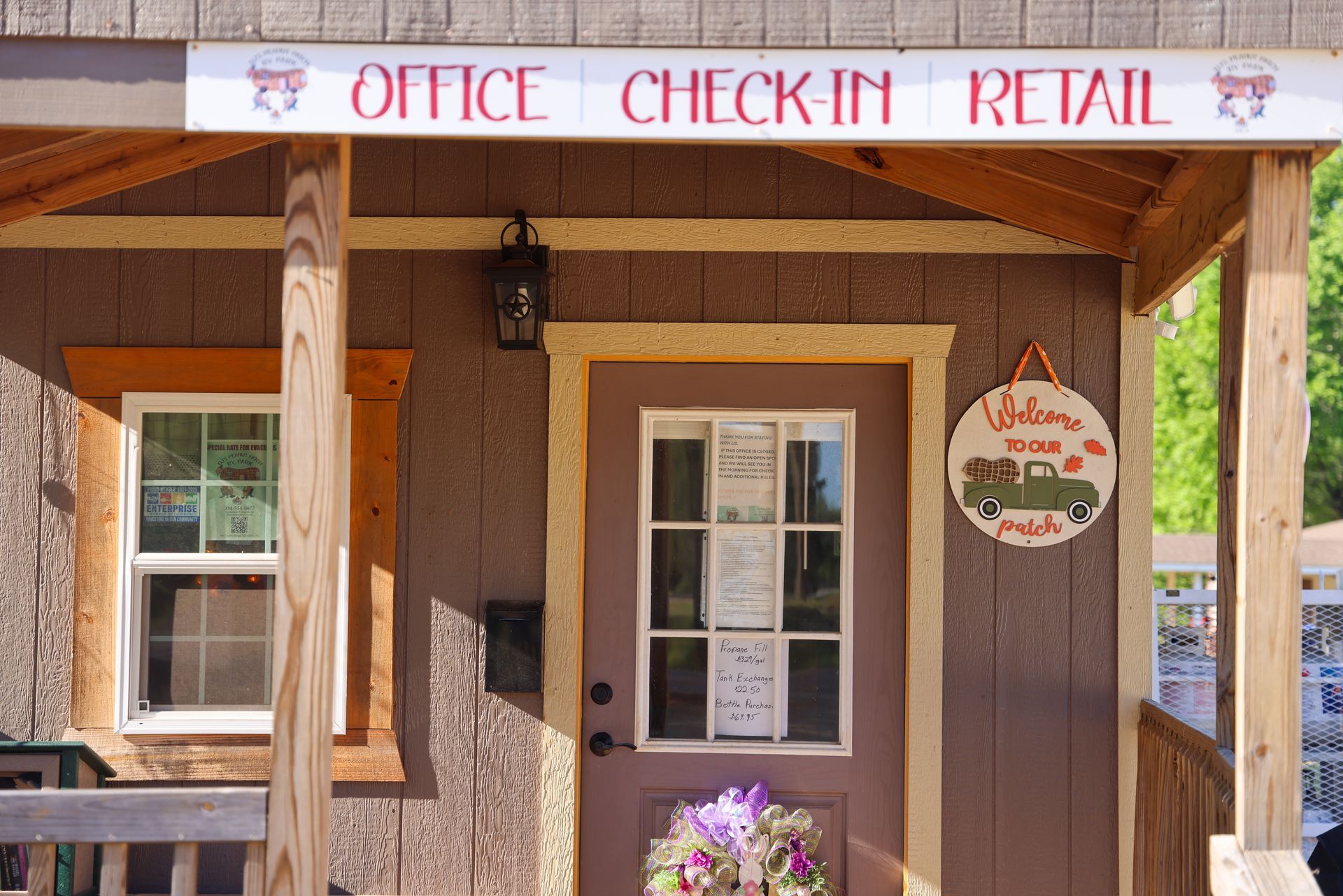 Rustic office check-in retail storefront with tan walls, wooden trim, and a hanging sign