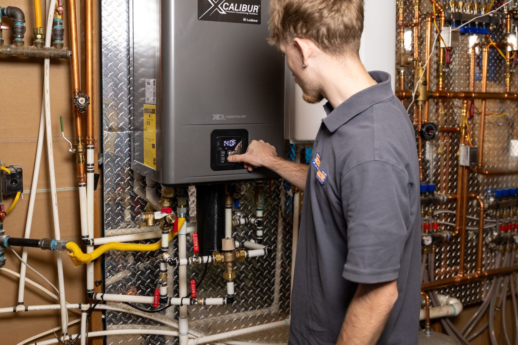 Three technicians reviewing a clipboard beside industrial pipes and filtration equipment