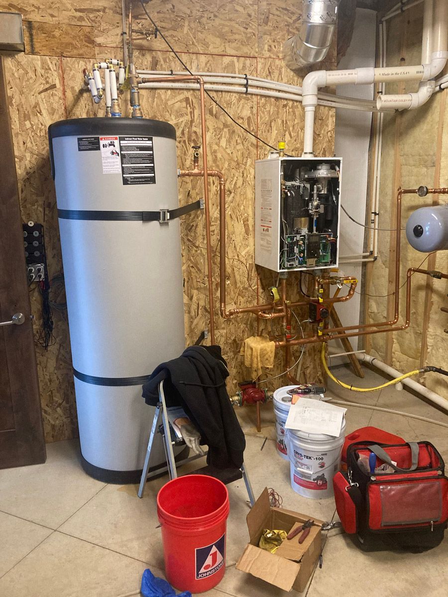 Indirect water heater and boiler installation in progress