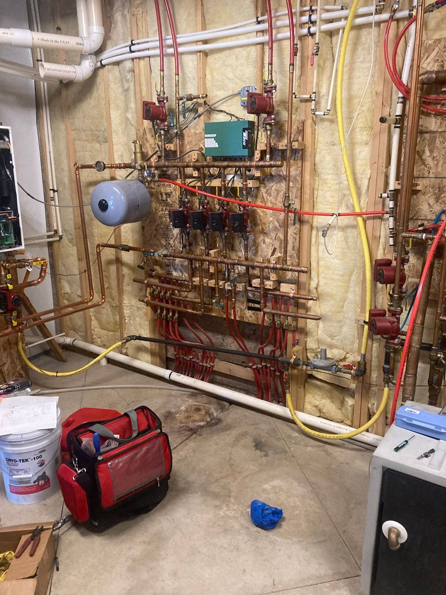 Radiant floor heating manifold connected to a newly installed boiler
