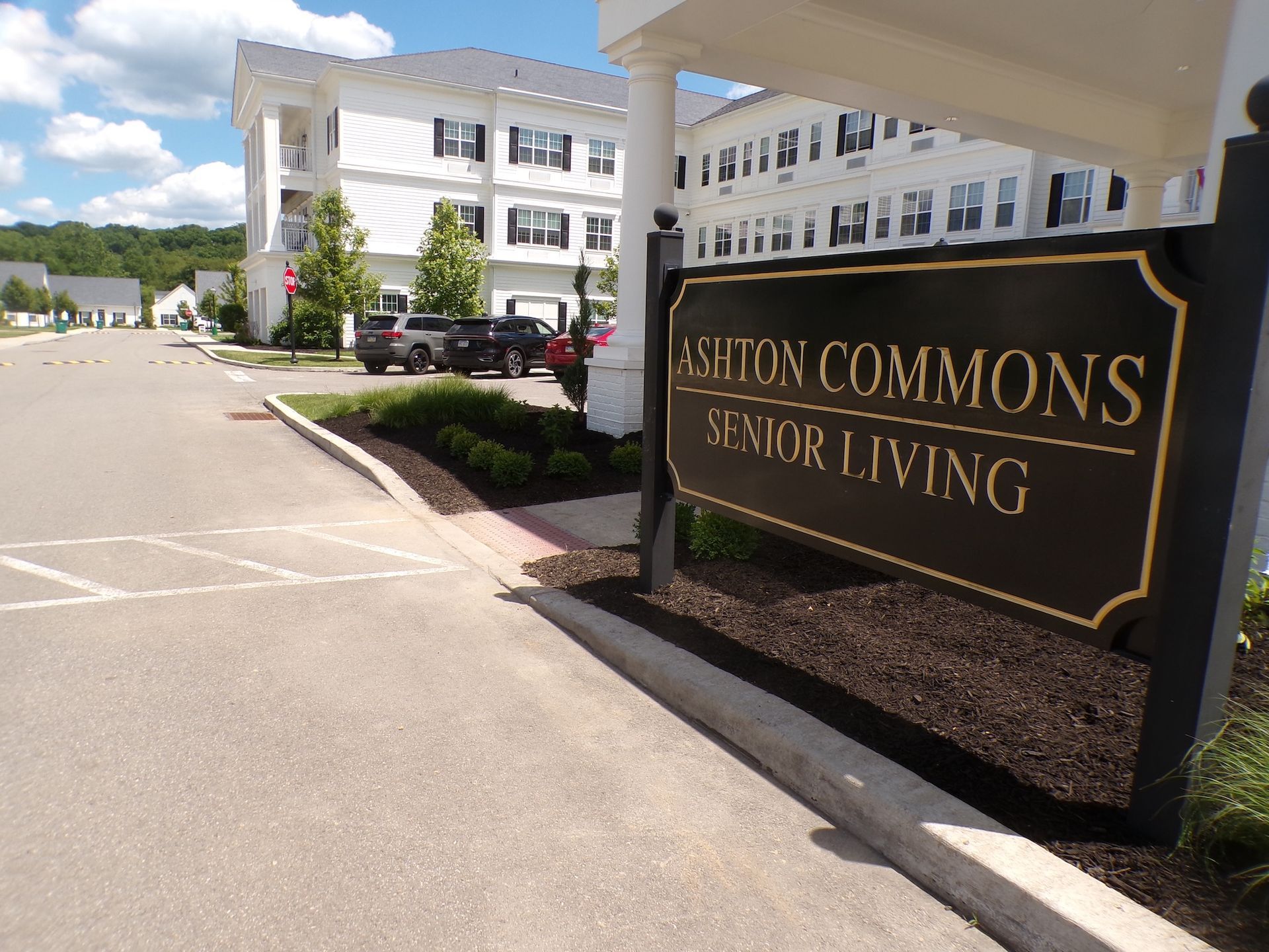 Seyton Commons Senior Living sign beside a white residential building and parking lot