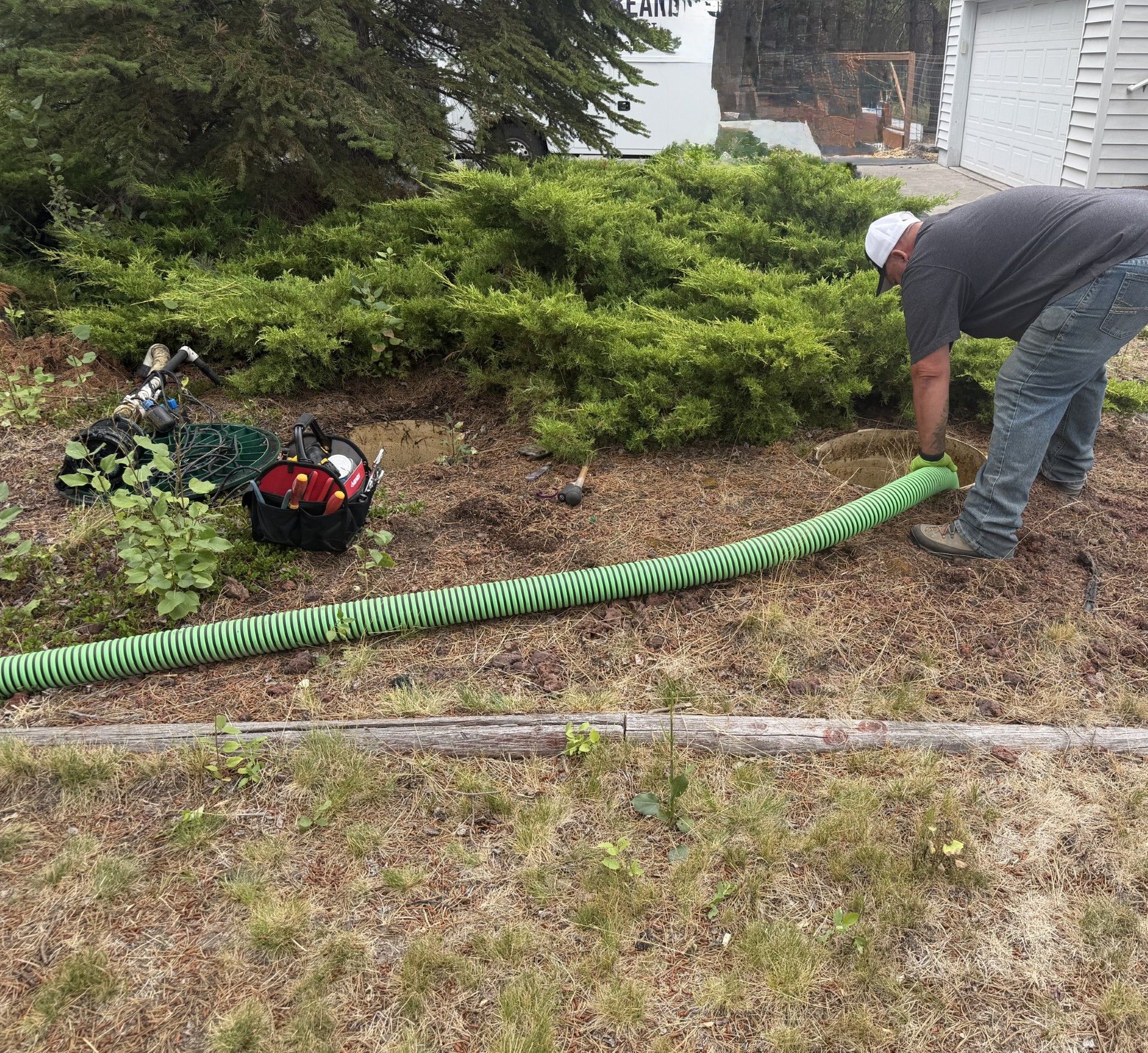 Septic technician servicing residential system at La Pine home