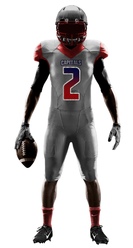 A football player in a gray and red uniform is holding a football.