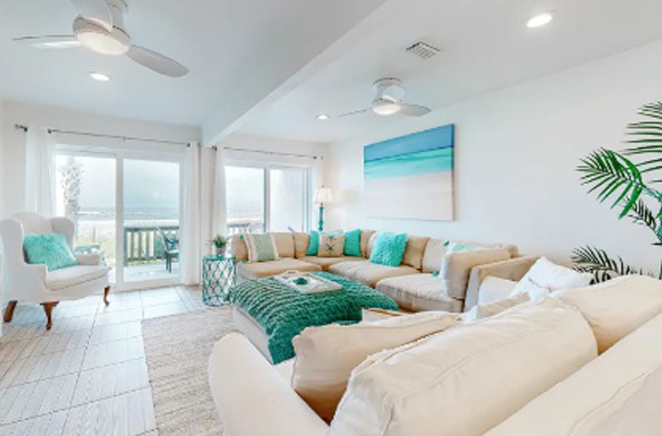 A living room filled with furniture and a ceiling fan.