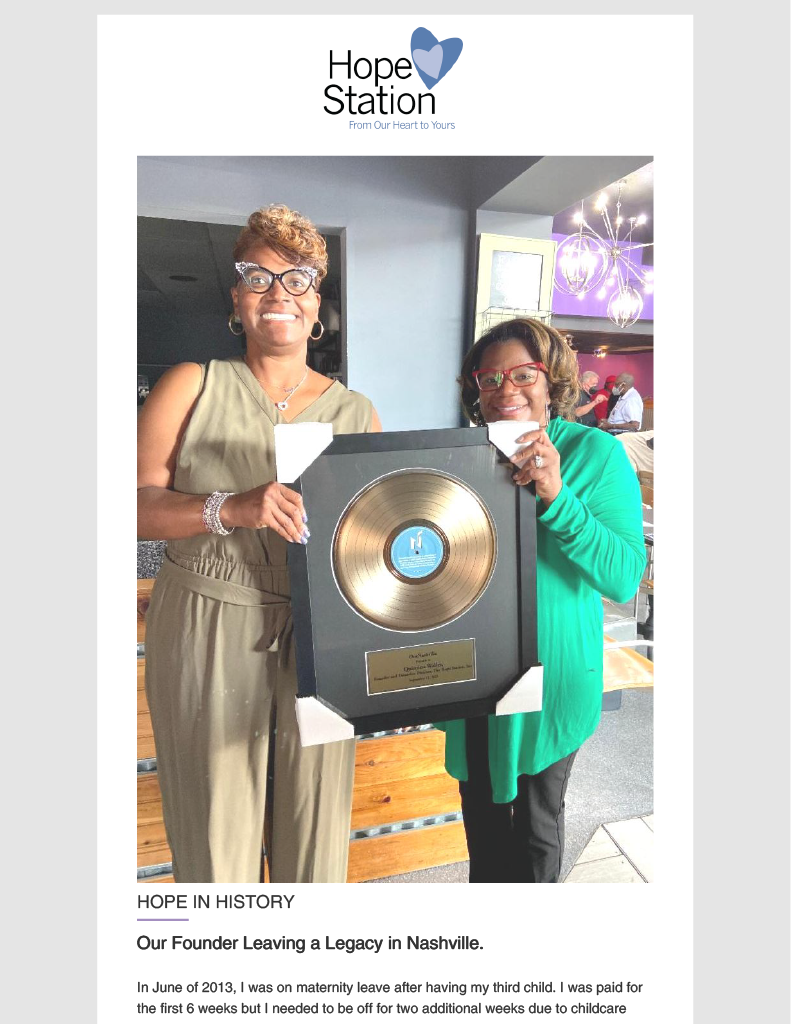 Two women are standing next to each other holding a gold record.