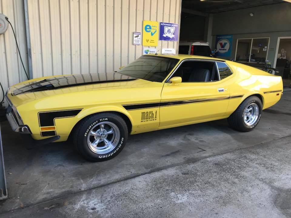 A Yellow Mustang Is Parked In Front Of A Building — Mechanic in Lismore, NSW