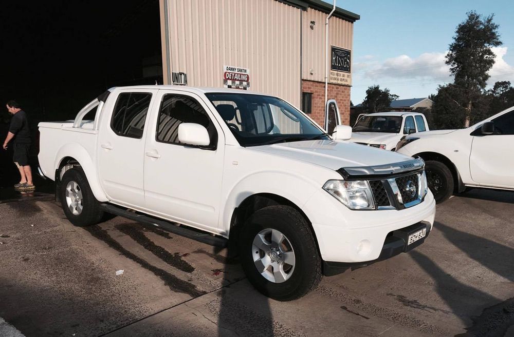 White Nissan Navara dual cab ute parked outside a tyre shop Lismore locals trust for mechanical and tyre services
