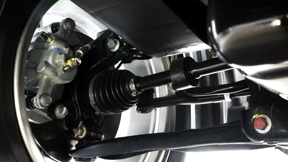 A Close Up Of The Underside Of A Car Showing The Brake Caliper — Mechanic in Lismore, NSW
