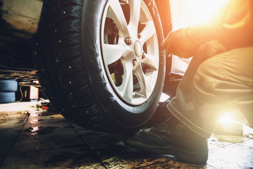 Mechanic Checking Tyres of A Vehicle