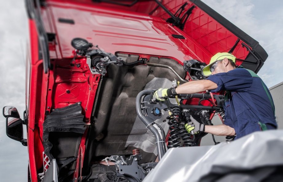 A Man is Working on the Engine of a Red Truck — Burmec In Narrabri, NSW