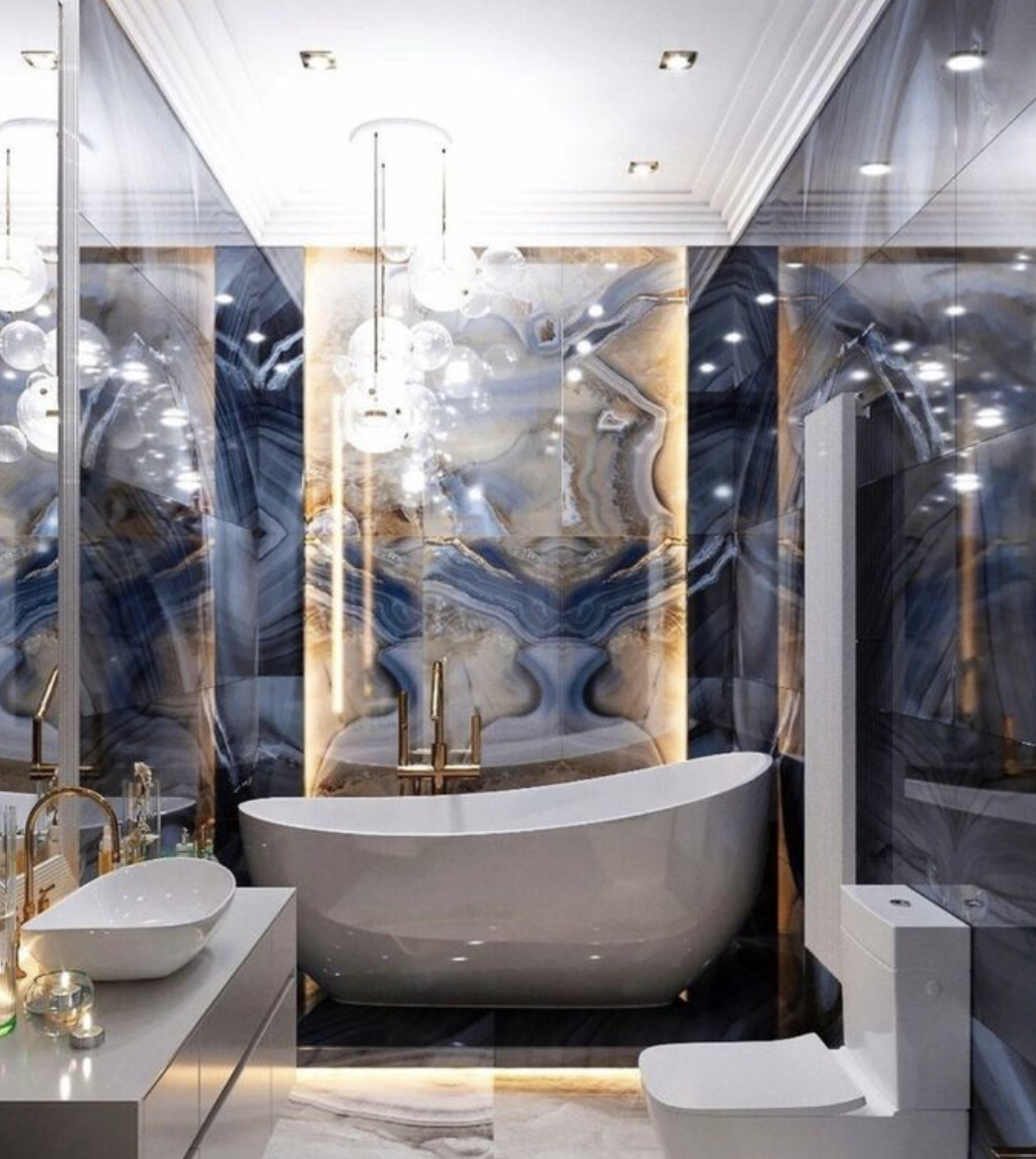Modern luxury bathroom with a freestanding tub, marble walls, and mirrored surfaces