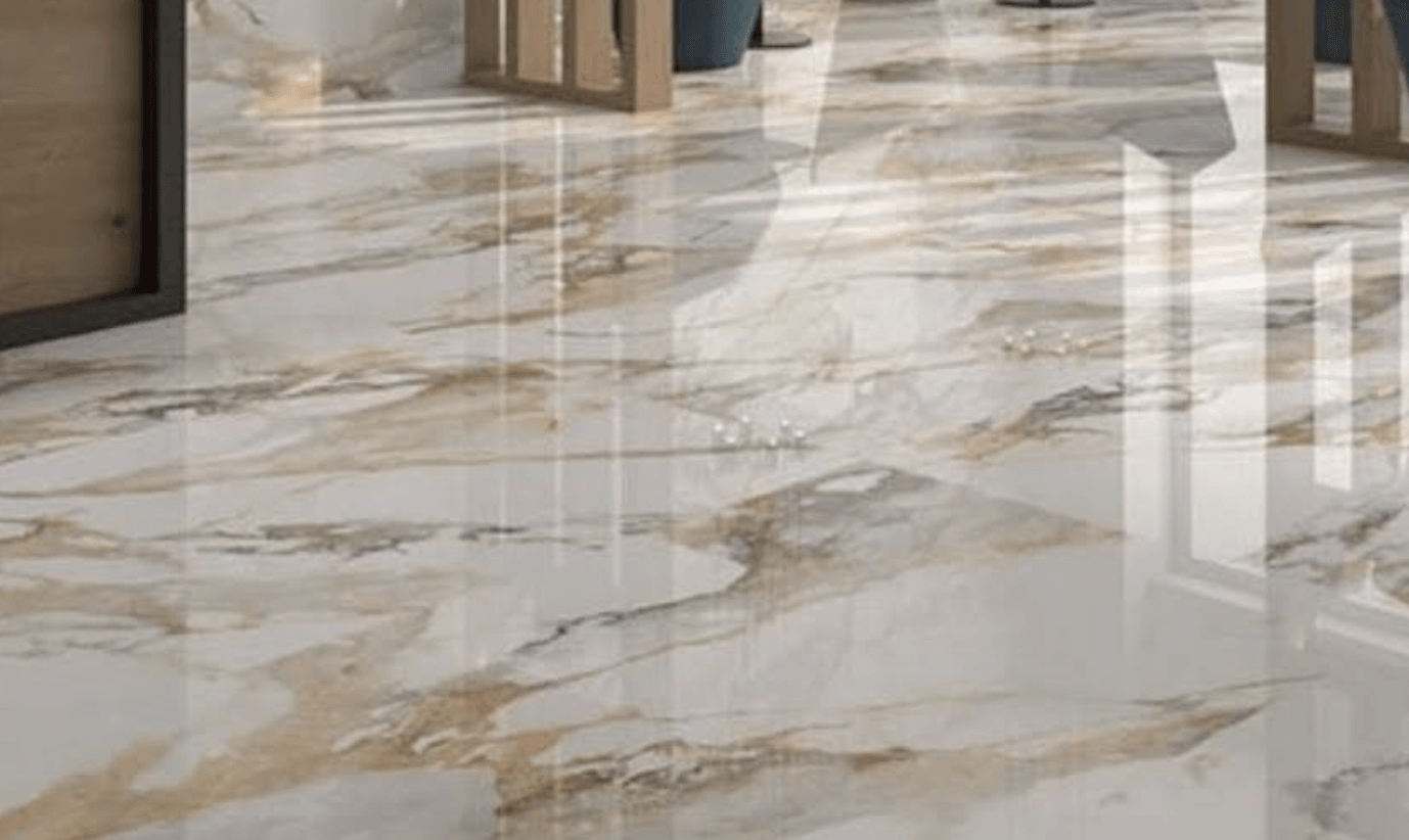 Polished marble lobby floor with gold and gray veining, glass doors in the background