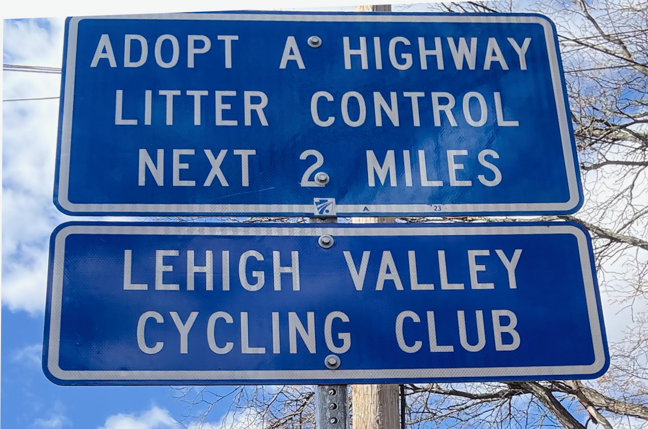 Blue Adopt-a-Highway sign: Lehigh Valley Cycling Club controls litter for the next 2 miles.